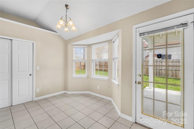 unfurnished dining area featuring light tile patterned floors, baseboards, a chandelier, and vaulted ceiling