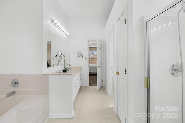 bathroom with vanity, ensuite bath, a shower stall, tile patterned floors, and a bath