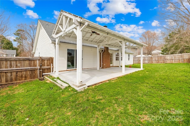 back of property featuring a fenced backyard, a lawn, a patio, and ceiling fan