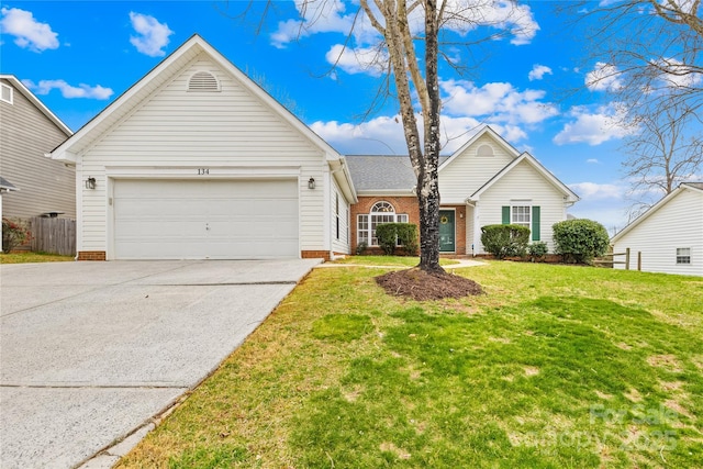 single story home featuring a garage, concrete driveway, a front yard, and fence