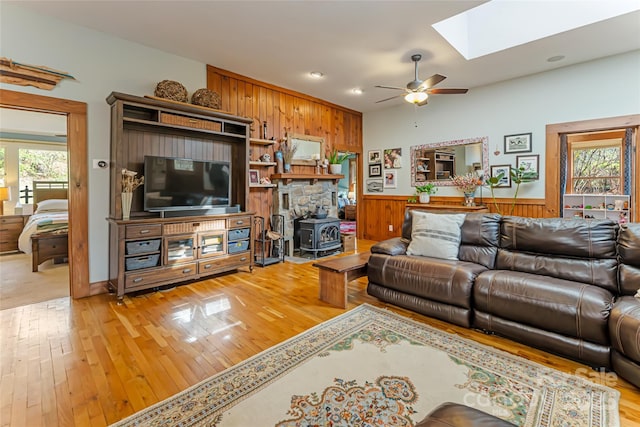 20 Meeks Rd, Black Mountain, NC 28711 - living room featuring a wood stove, a skylight, a ceiling fan, and a healthy amount of sunlight