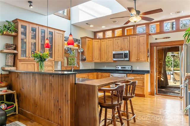20 Meeks Rd, Black Mountain, NC 28711 - kitchen with light wood-style flooring, a towering ceiling, visible vents, appliances with stainless steel finishes, and dark countertops