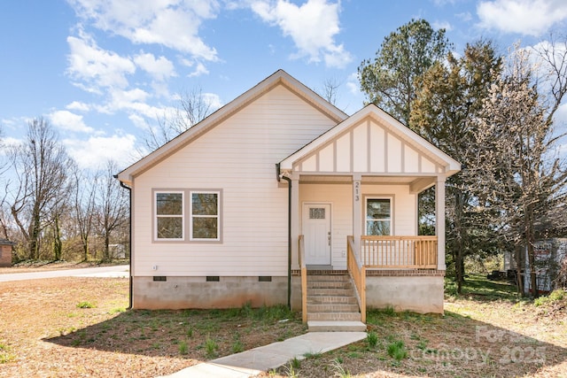 bungalow-style home featuring a porch, board and batten siding, and crawl space