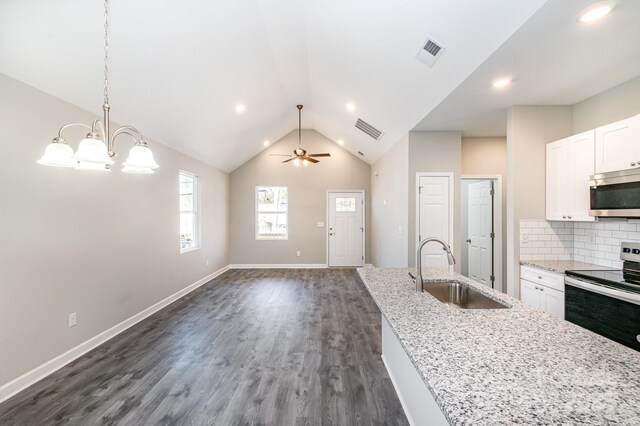 kitchen with a sink, visible vents, appliances with stainless steel finishes, and white cabinets