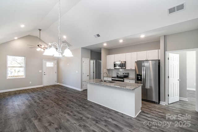 kitchen featuring a sink, visible vents, appliances with stainless steel finishes, and a center island with sink