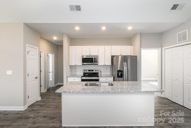 kitchen with visible vents, stainless steel appliances, and a sink