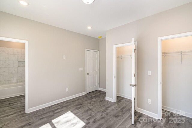 unfurnished bedroom featuring wood finished floors and baseboards