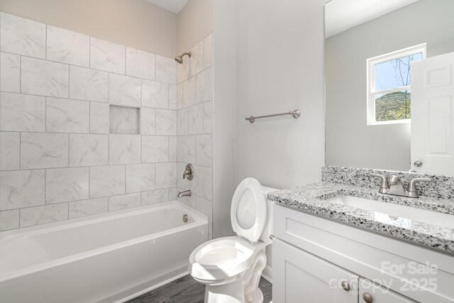 bathroom featuring vanity, toilet, and washtub / shower combination