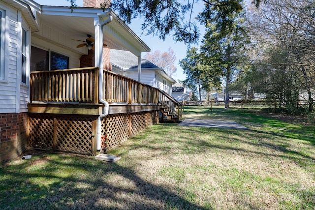 view of yard with a patio area, a deck, ceiling fan, and fence