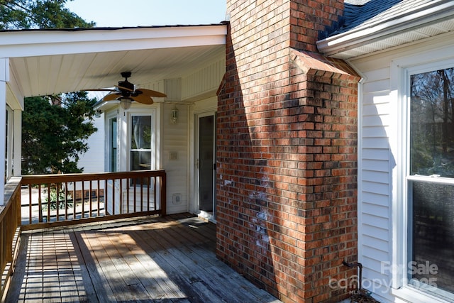 wooden terrace featuring a ceiling fan