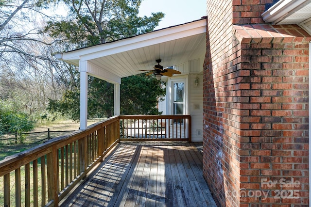 wooden deck featuring a ceiling fan