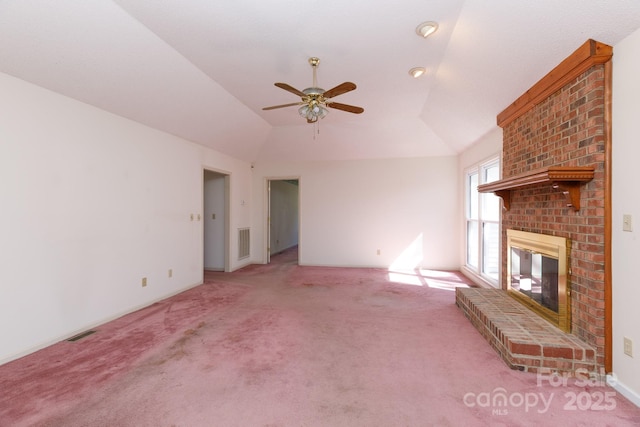 unfurnished living room with light carpet, visible vents, a brick fireplace, and lofted ceiling