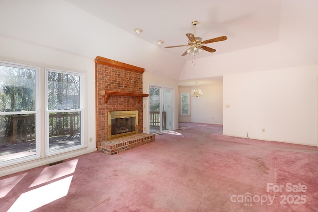 unfurnished living room with a wealth of natural light, visible vents, carpet, and a brick fireplace