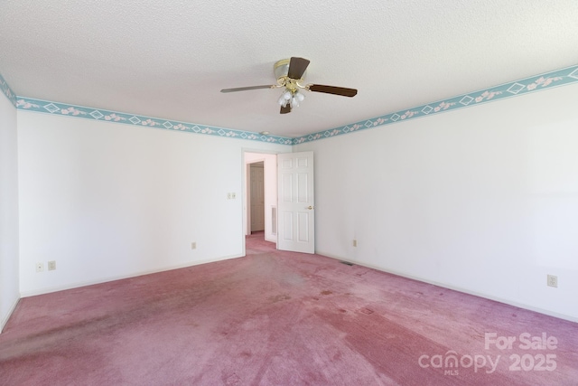 empty room with carpet flooring, a textured ceiling, baseboards, and a ceiling fan