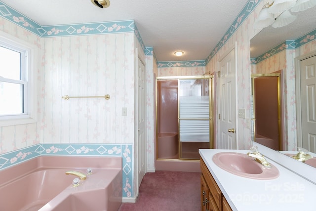 full bath featuring vanity, wallpapered walls, a shower stall, a textured ceiling, and a garden tub