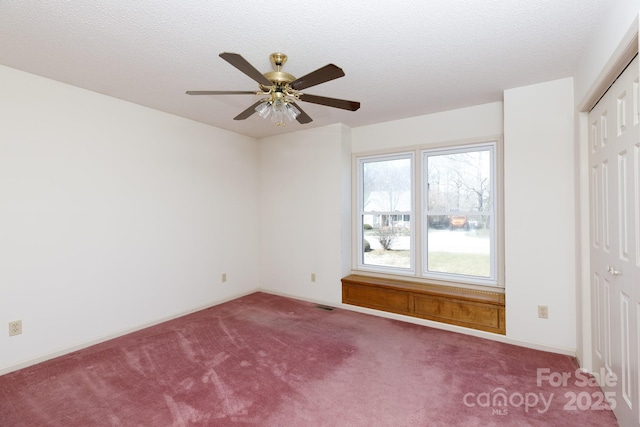 unfurnished bedroom with a closet, visible vents, carpet flooring, and a textured ceiling