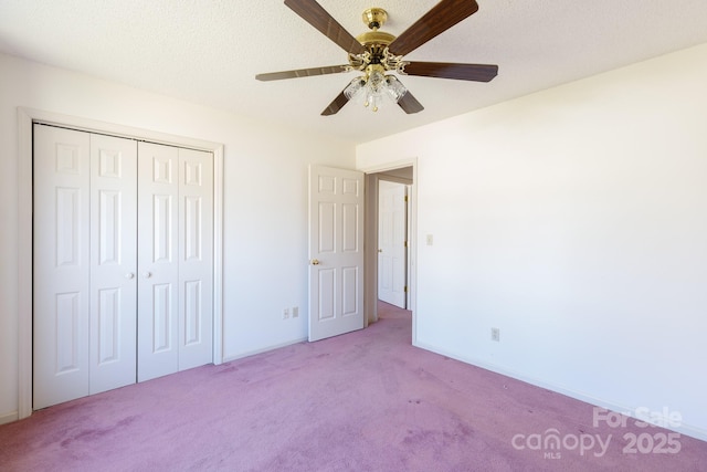 unfurnished bedroom with a closet, ceiling fan, a textured ceiling, and carpet