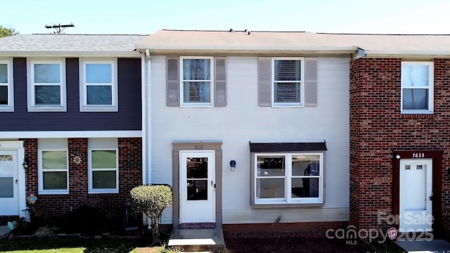 view of property with elevator and brick siding