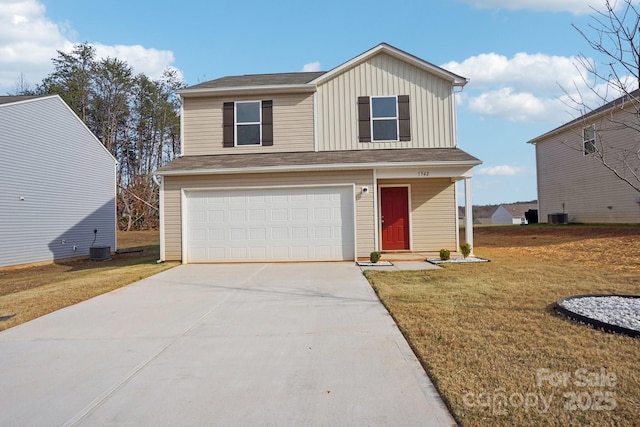 traditional-style house with board and batten siding, concrete driveway, central AC, a front yard, and a garage