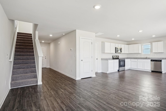 kitchen with dark wood finished floors, recessed lighting, white cabinets, and stainless steel appliances