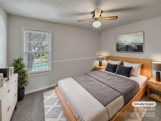 carpeted bedroom with a ceiling fan, baseboards, and a textured ceiling