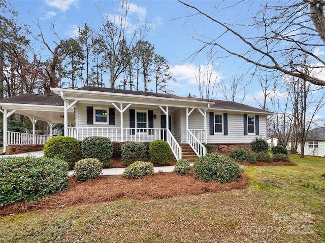 single story home featuring a carport, covered porch, brick siding, and a front yard