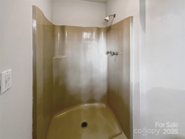 full bath with a shower stall