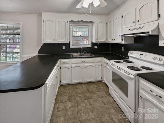 kitchen with dark countertops, under cabinet range hood, a peninsula, white electric stove, and a sink