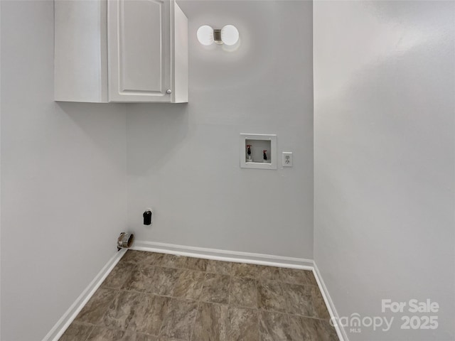 laundry area with cabinet space, baseboards, and washer hookup