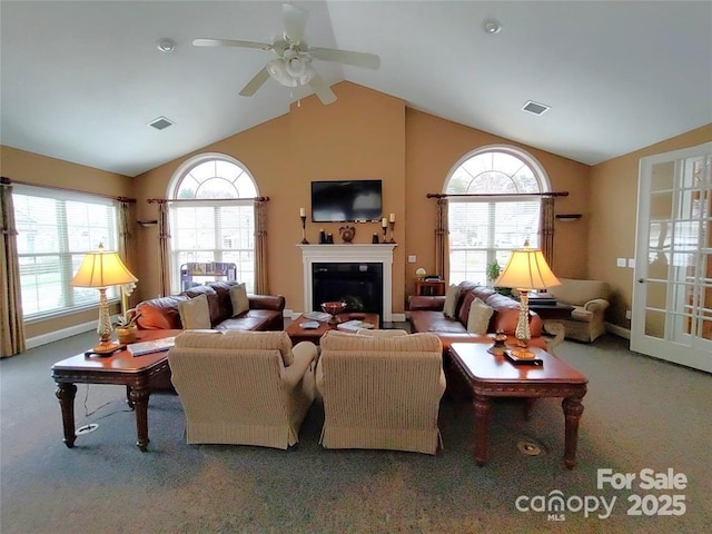824 Wynnshire Dr Unit D, Hickory, NC 28601 - carpeted living room with vaulted ceiling, a ceiling fan, a glass covered fireplace, plenty of natural light, and baseboards