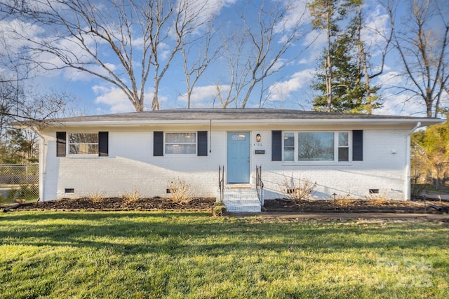 ranch-style house with crawl space, a front yard, brick siding, and fence