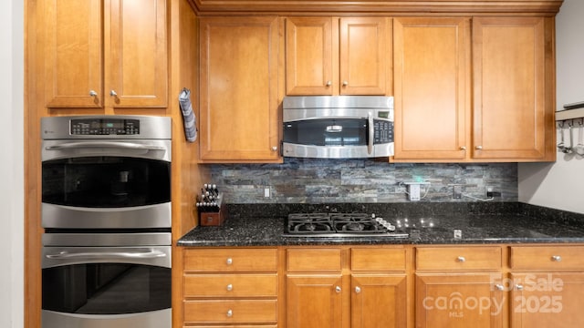 kitchen featuring dark stone countertops, tasteful backsplash, and stainless steel appliances