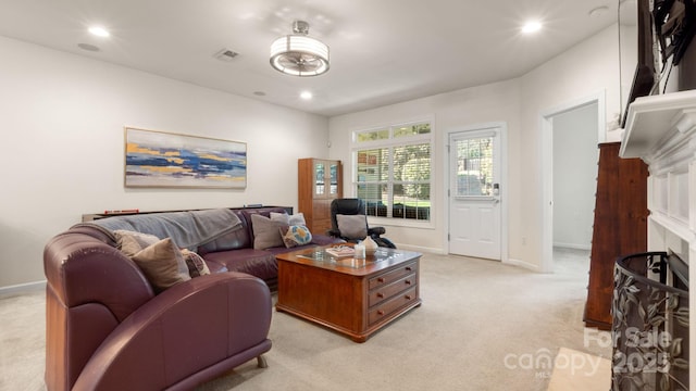 living area with light colored carpet, recessed lighting, and visible vents