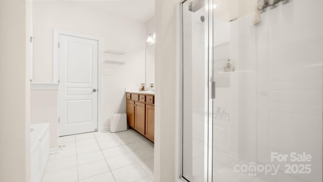 bathroom featuring tile patterned flooring, a stall shower, vanity, and a bath