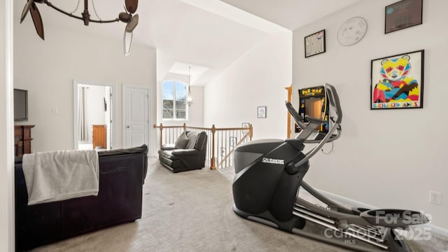 exercise area featuring a notable chandelier and carpet flooring