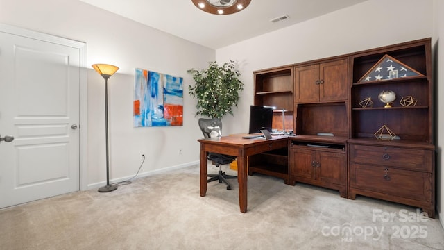 office area featuring visible vents, baseboards, and light colored carpet