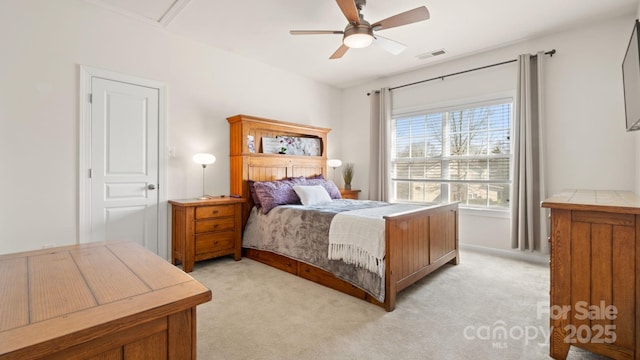 bedroom featuring visible vents, light colored carpet, and ceiling fan