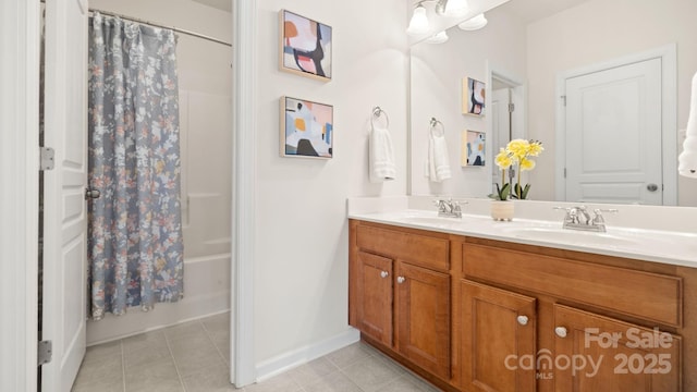 full bathroom with tile patterned flooring, double vanity, shower / bath combo with shower curtain, and a sink