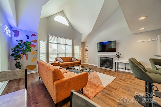 513 N Graham St Unit 3H, Charlotte, NC 28202 - living area with baseboards, recessed lighting, high vaulted ceiling, a tile fireplace, and wood finished floors