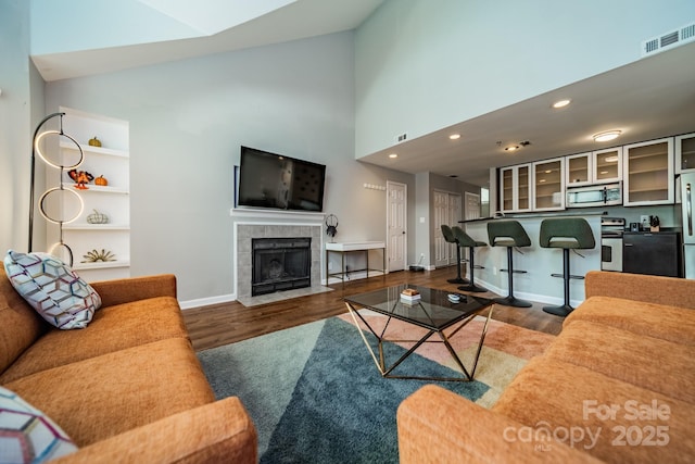 513 N Graham St Unit 3H, Charlotte, NC 28202 - living area with wood finished floors, a fireplace, baseboards, and visible vents