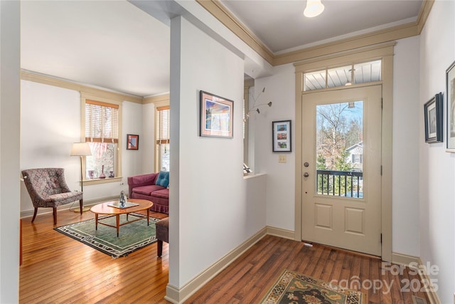 entrance foyer with hardwood / wood-style floors, baseboards, and ornamental molding