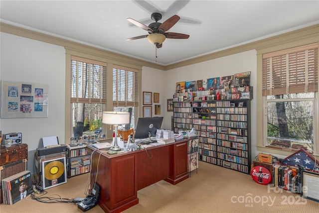 office area featuring light colored carpet, a ceiling fan, and ornamental molding