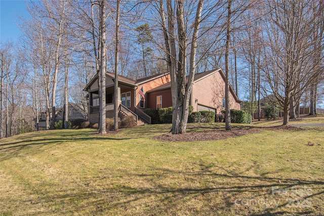 view of home's exterior featuring covered porch, a lawn, and a garage