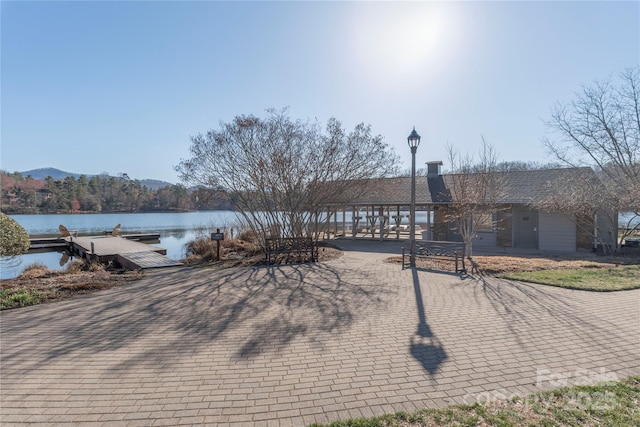 view of front facade with a dock and a water view