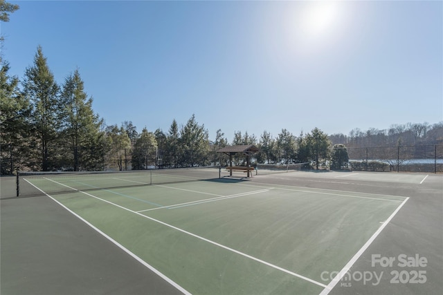 view of sport court featuring fence