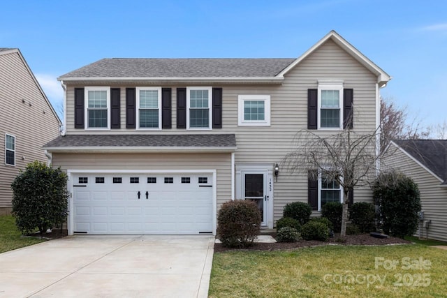 view of front facade featuring a garage, a front yard, roof with shingles, and driveway