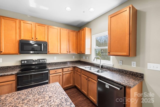 kitchen featuring a sink, recessed lighting, range with two ovens, dishwashing machine, and dark wood-style flooring