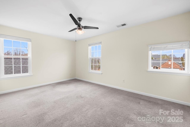 unfurnished room featuring visible vents, baseboards, and carpet floors