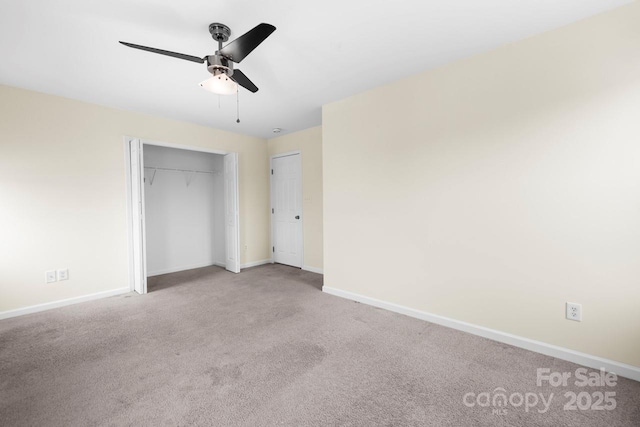 unfurnished bedroom with carpet flooring, a ceiling fan, and baseboards