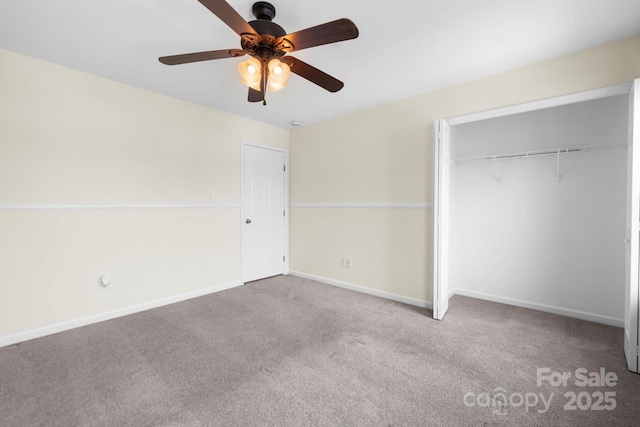 unfurnished bedroom with carpet flooring, baseboards, a closet, and ceiling fan